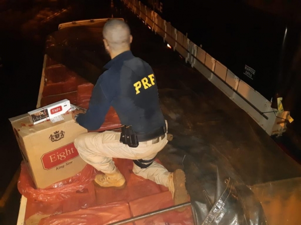 Os policiais encontraram o compartimento de carga carregado com aproximadamente 20 mil pacotes de cigarros. (Fotos: Divulgação/PRF)